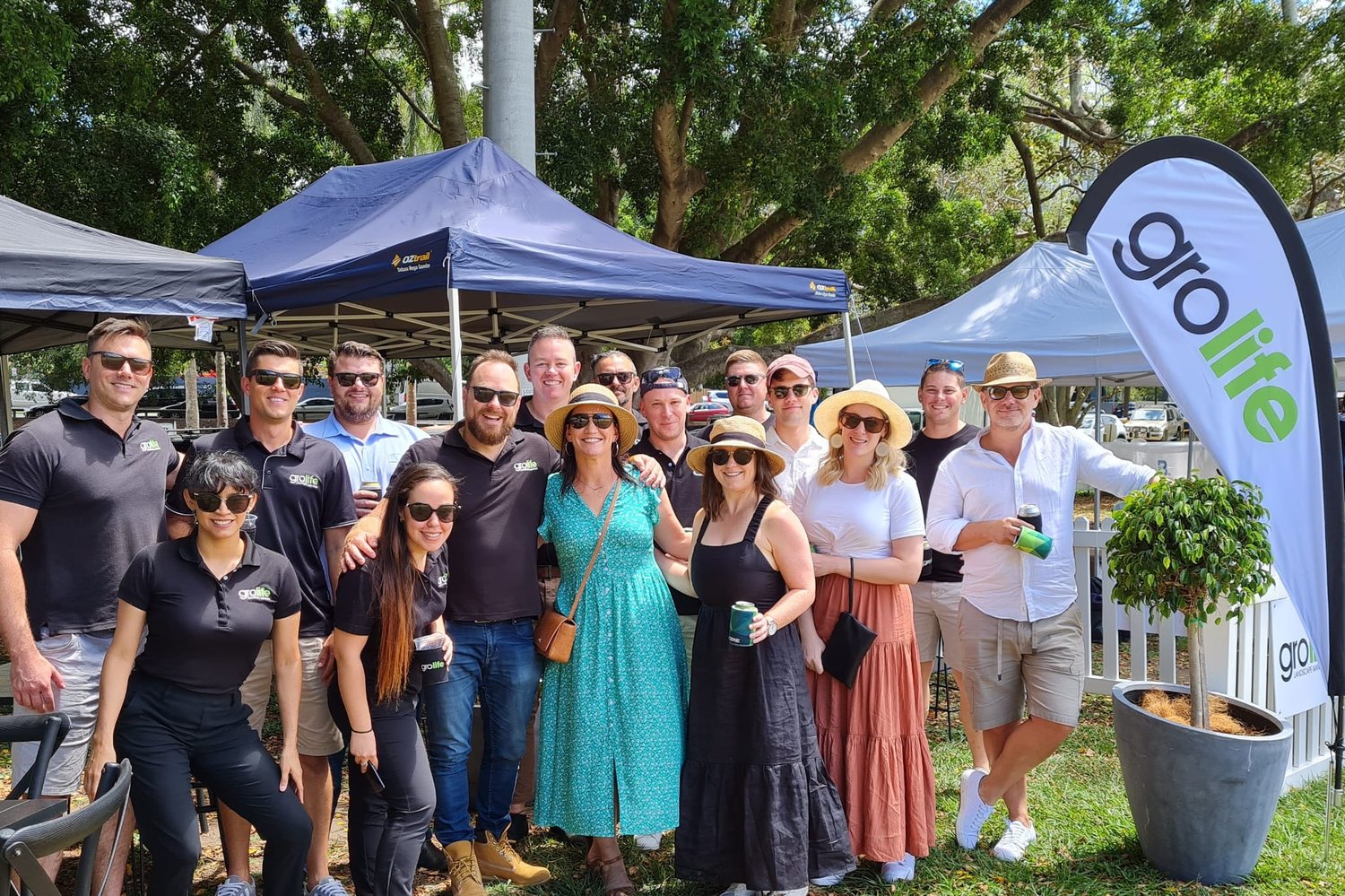 The Grolife team at a family day event under marquees with Grolife flags