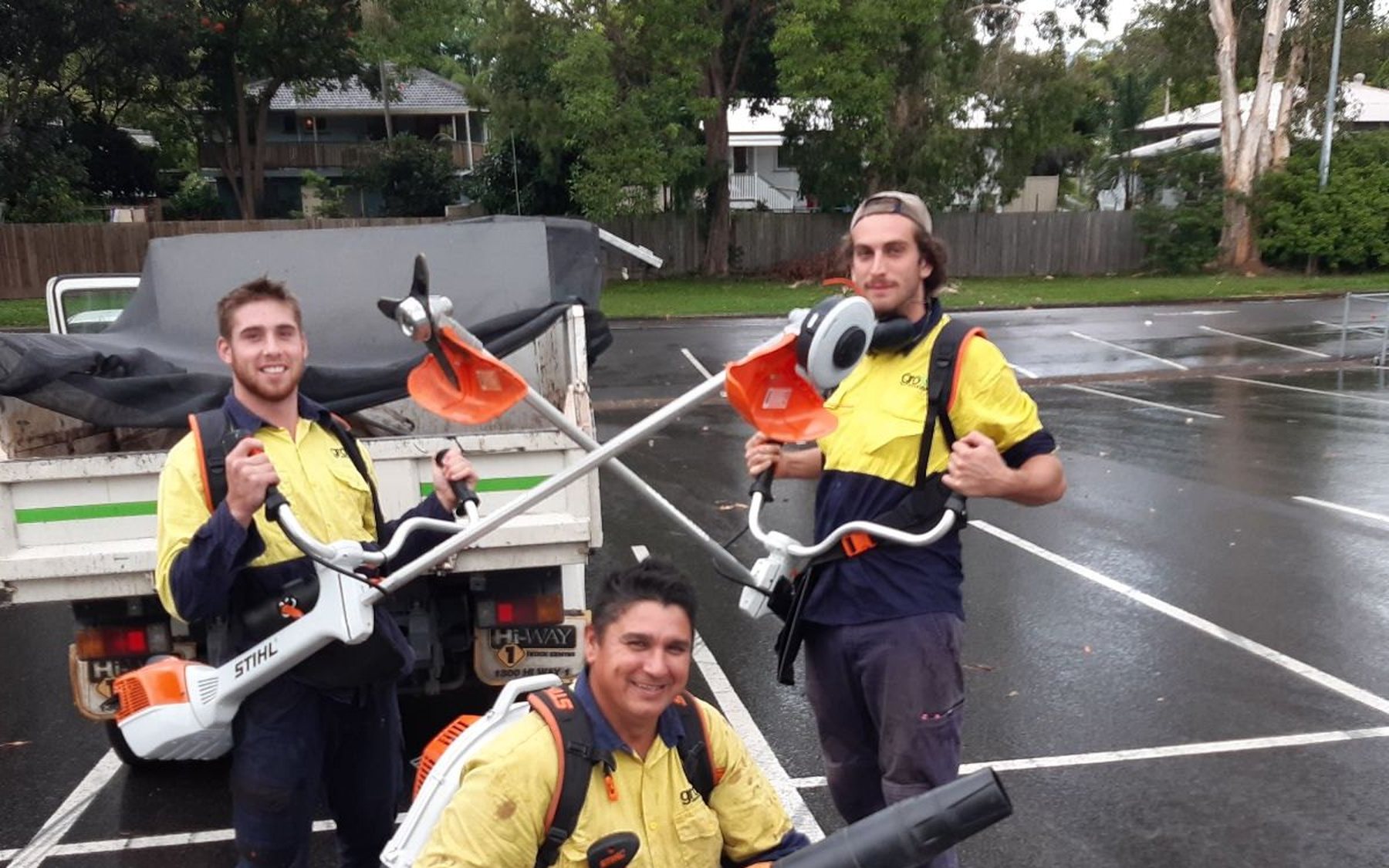 Three Grolife crew members with the latest commercial battery-electric tools — blowers, trimmers, full PPE